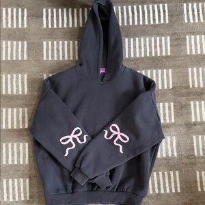 Edikted Dark Gray Hoodie with Pink bows on the sleeves.